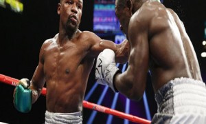 Floyd Mayweather Jr. hits Andre Berto during their welterweight title boxing bout Saturday, Sept. 12, 2015, in Las Vegas. (AP Photo/John Locher)