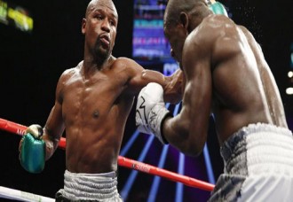 Floyd Mayweather Jr. hits Andre Berto during their welterweight title boxing bout Saturday, Sept. 12, 2015, in Las Vegas. (AP Photo/John Locher)