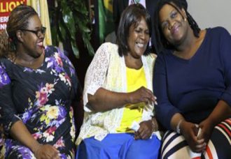 Pearlie Mae Smith, second right, reacts as she sits with daughters Rene Bethina Smith, third right, and Katherine Nicole Nunnally, right, and five other children, not shown, as they talk about life after winning the lottery Friday, May 13, 2016 in Lawrenceville, N.J. The eight family members will claim their share of last weekend's $429.6 million Powerball jackpot, which was won with a $6 investment. The trip to claiming the jackpot began last week at a 7-Eleven in Trenton when someone bought two $2 tickets, one each for drawings held last Wednesday and Saturday, and spent an extra $1 on each ticket to get the "Power Play" option that multiplies the winnings.  (AP Photo/Mel Evans)